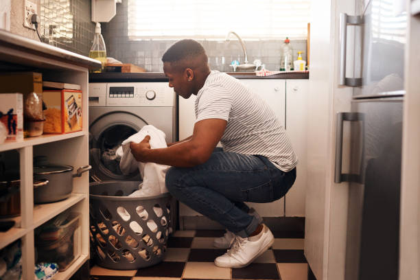 Shot of a man doing the laundry at home